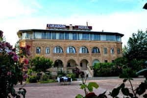 a building with a sign on top of it at Turabdin Hotel in Midyat