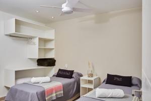 two beds in a room with white walls at Viví Potrerillos in Potrerillos +54 photos