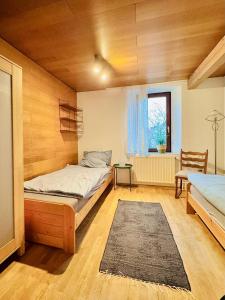 a bedroom with a bed and a chair and a window at Starkenburgblick in Heppenheim an der Bergstrasse +7 photos