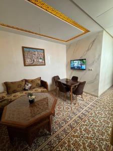 a living room with a couch and a table at Appartement Dar LALA 1 in Fez +4 photos