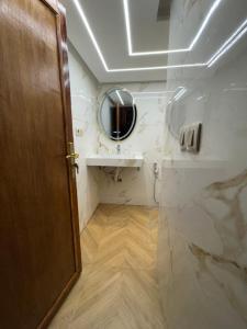 a bathroom with a sink and a mirror at Appartement Dar LALA 1 in Fez