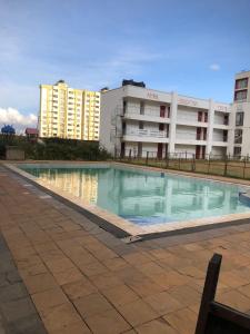 a large swimming pool in front of a building at Sunstone Studio- Ngong Rd Near Junction Mall in Nairobi