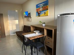 a living room with a table and a couch at Loft incrível e completo in São Lourenço do Sul