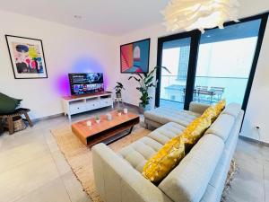 a living room with two couches and a tv at Lovely 1 bedroom apartment w balcony&parking-BON10 in Luxembourg