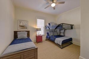 a bedroom with two bunk beds and a ceiling fan at Tipsy Turtle - 1227 Beachview Drive in East End
