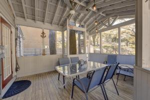 a dining room with a glass table and chairs at Tipsy Turtle - 1227 Beachview Drive in East End