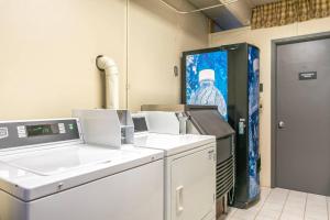 a laundry room with machines and a picture of a man at Lift House Lodge, Downtown Vail Lionshead Village Studio Condo in Vail +38 photos