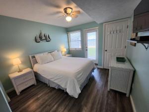 a bedroom with a white bed and two night stands at North Shore Inn TC 102 in Traverse City +18 photos