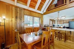 a kitchen and dining room with a wooden table and chairs at The Hideaway in Meadow Lake Park