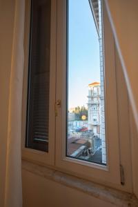a window with a view of a city at 56 Orange Street Luxury Accommodation in Rome
