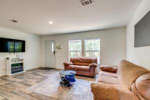 a living room with two couches and a tv at Bovees Riverhouse Dunnellon Family Getaway! in Dunnellon