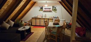 a living room with a table and a kitchen at Snašini kućari in Gradište