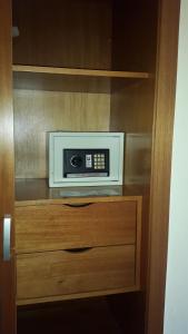a microwave sitting on top of a wooden cabinet at Embajador Hotel in Buenos Aires