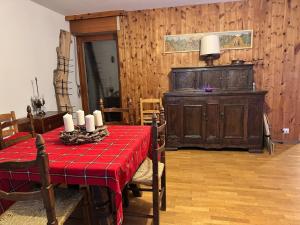 a dining room with a table with a red table cloth at The Queen in the Snow in Courmayeur