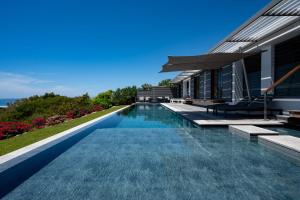 a swimming pool in front of a house at Villa Belle Galante in Grand-Bourg +58 photos