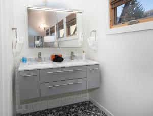 a bathroom with a sink and a mirror at 2633 Kinnickinnick Rd., Unit E2 in Vail +32 photos