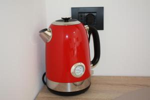 a red electric kettle is sitting on a counter at The One Malpensa Rooms in Vizzola Ticino