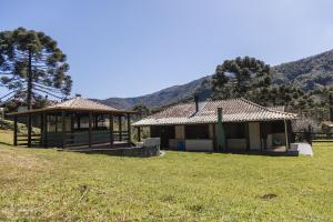 a house with a gazebo in a field at Cabana em Urubici Serra do Corvo Branco in Urubici +19 photos