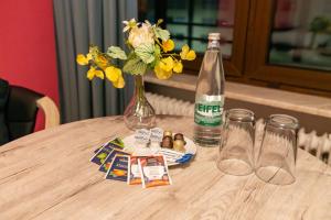 a table with a bottle of water and a vase with flowers at RheinmeetsMosel Rheinufer Deutsches Eck in Koblenz