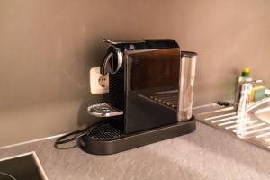 a toaster oven sitting on top of a kitchen counter at RheinmeetsMosel Rheinufer Deutsches Eck in Koblenz