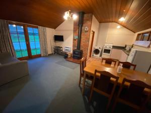 an aerial view of a living room with a table and chairs at Oultan Homestead Farm Stay in Ikamatua