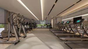 a gym with a row of tread machines at voco Jeddah Gate by IHG in Jeddah