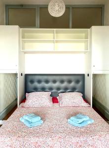 a bedroom with a bed with two towels on it at Chez Mo in Lyon
