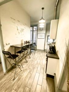 a kitchen and dining room with a table and chairs at Chez Mo in Lyon +6 photos