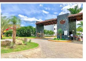 a gas station in a park with a palm tree at Casa La Fragata in Zihuatanejo