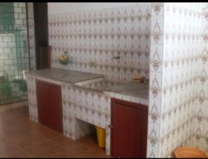 a kitchen with a counter and a sink in a room at Casa praia Guarapari in Guarapari +18 photos