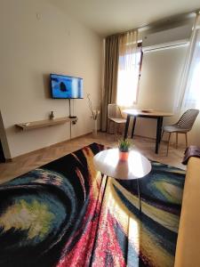 a living room with a couch and a table at Nature Life, 200m to the Lift in Bansko