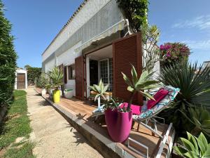 a house with a porch with plants and a chair at Parrot Cage - the Gay Villa in Playa del Ingles