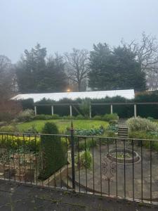 a garden with a fence in front of a building at The Bishops in London