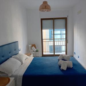 a bedroom with a large bed with two towels on it at María PLAYA 1 NG in Peniscola