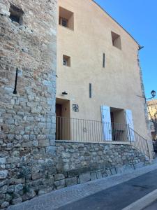 a stone building with a balcony on the side of it at Love Room La Tour in Montmeyan
