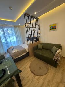 a living room with a couch and a bed at Apartman B64 Residence Hill Kopaonik in Kopaonik +17 photos