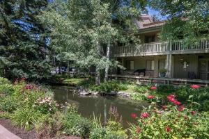 a house with a pond in front of it at Cottonwood Condo 1469 in Sun Valley