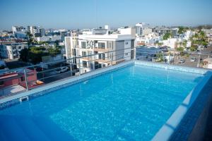 a large swimming pool on top of a building at 2br/2ba Condo 1 block to ocean! - Unit #5 in Mazatlán
