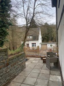 a patio in front of a house with a fence at Ferienwohnung Burgunderwiese in Bad Neuenahr-Ahrweiler