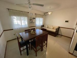 a living room with a table and chairs and a couch at SORRENTO Céntrico con cochera in Villa Carlos Paz
