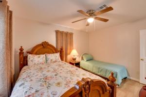 a bedroom with a bed and a ceiling fan at Walking Distance to Casino Home in Westlake! in Westlake