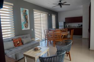 a living room with a couch and a table with chairs at 2br/2ba Condo 1 block to ocean! - Unit 4 in Mazatlán