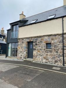 a stone building with a door on a street at 244 Seatown Cullen Moray Scotland in Cullen