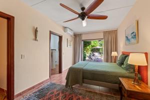 a bedroom with a bed and a ceiling fan at Villa Casablanca in Willemstad +49 photos