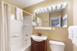 a bathroom with a sink and a toilet and a mirror at Crystal Beach in McCall +25 photos