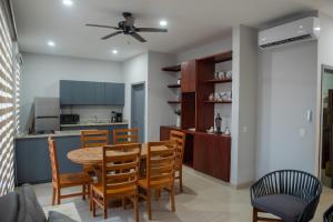 a kitchen and dining room with a table and chairs at 2br/2ba Condo 1 block to ocean! - Unit 3 in Mazatlán