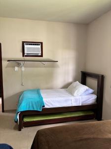 a bedroom with a bed with a air conditioner on the wall at Casa Barra Mar in Saquarema +130 photos