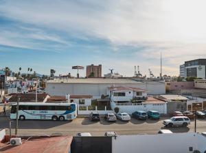 a bus parked in a parking lot next to cars at Marloma departamento #2 in Ensenada