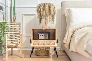 a bedside table with a laptop on it next to a bed at Central Premium Residence Beachfront in Durrës +42 photos