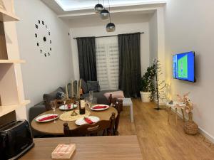 a living room with a table and a dining room at Stan na dan Maksim in Sarajevo